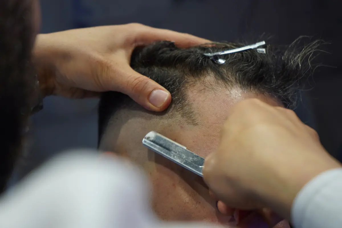 Straight razor cleaning up a hairline