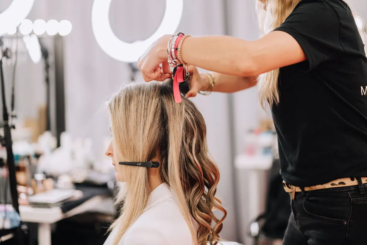 Stylist sectioning blonde hair
