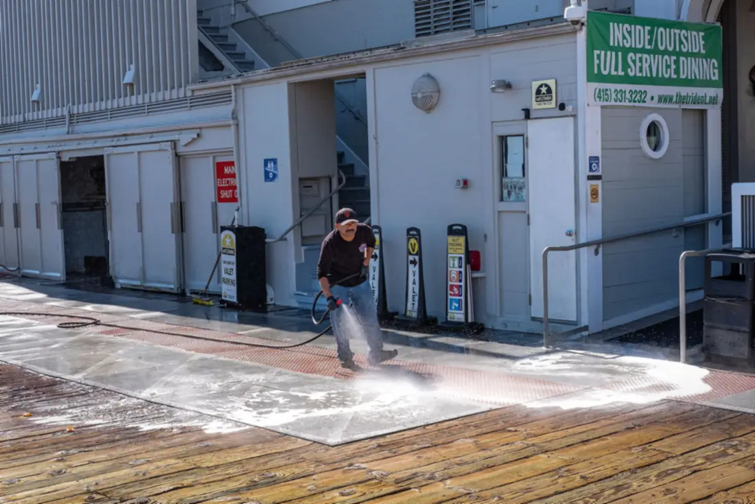 Pressure washing a concrete walkway